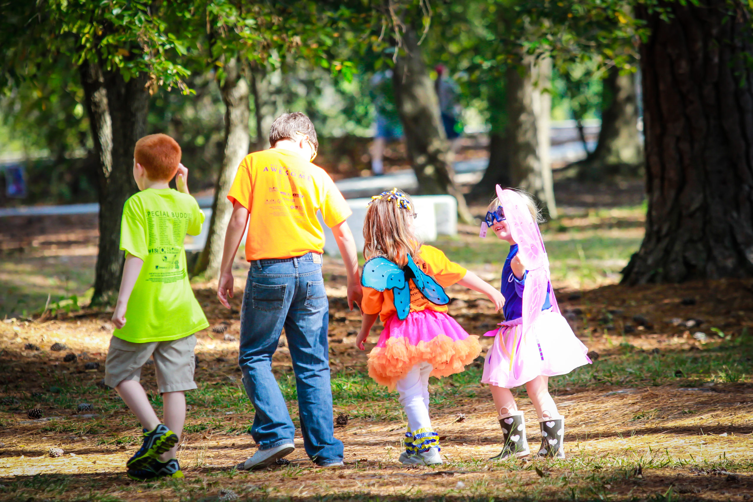 Image of four children walking Image of 2 boys and two girls walking outdoors