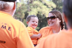 Image of an Adult holding a smiling child Image of an Adult holding a smiling child