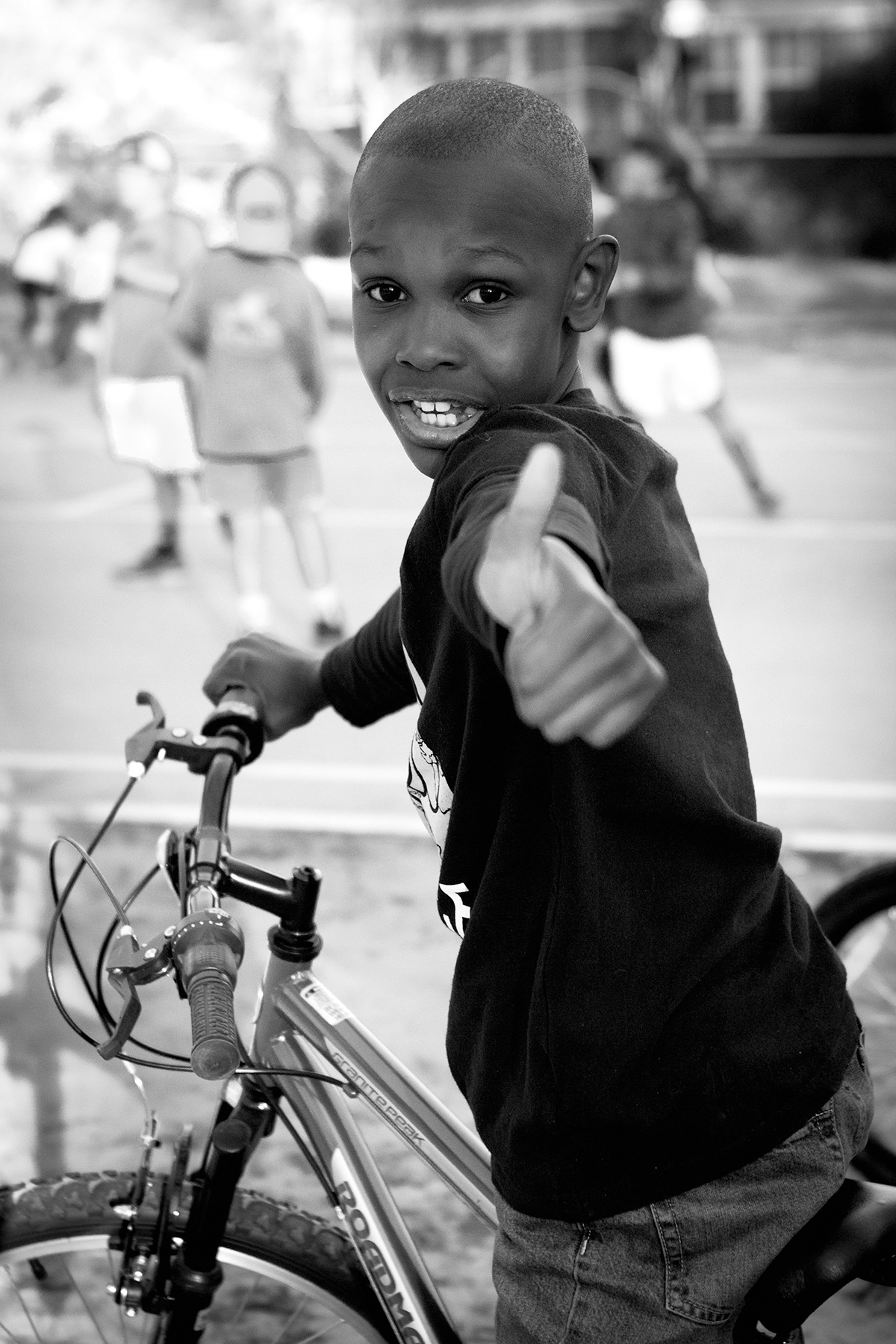 24-FCSC-Look-Forward-2017 image of youth riding a bike and giving a thumbs up