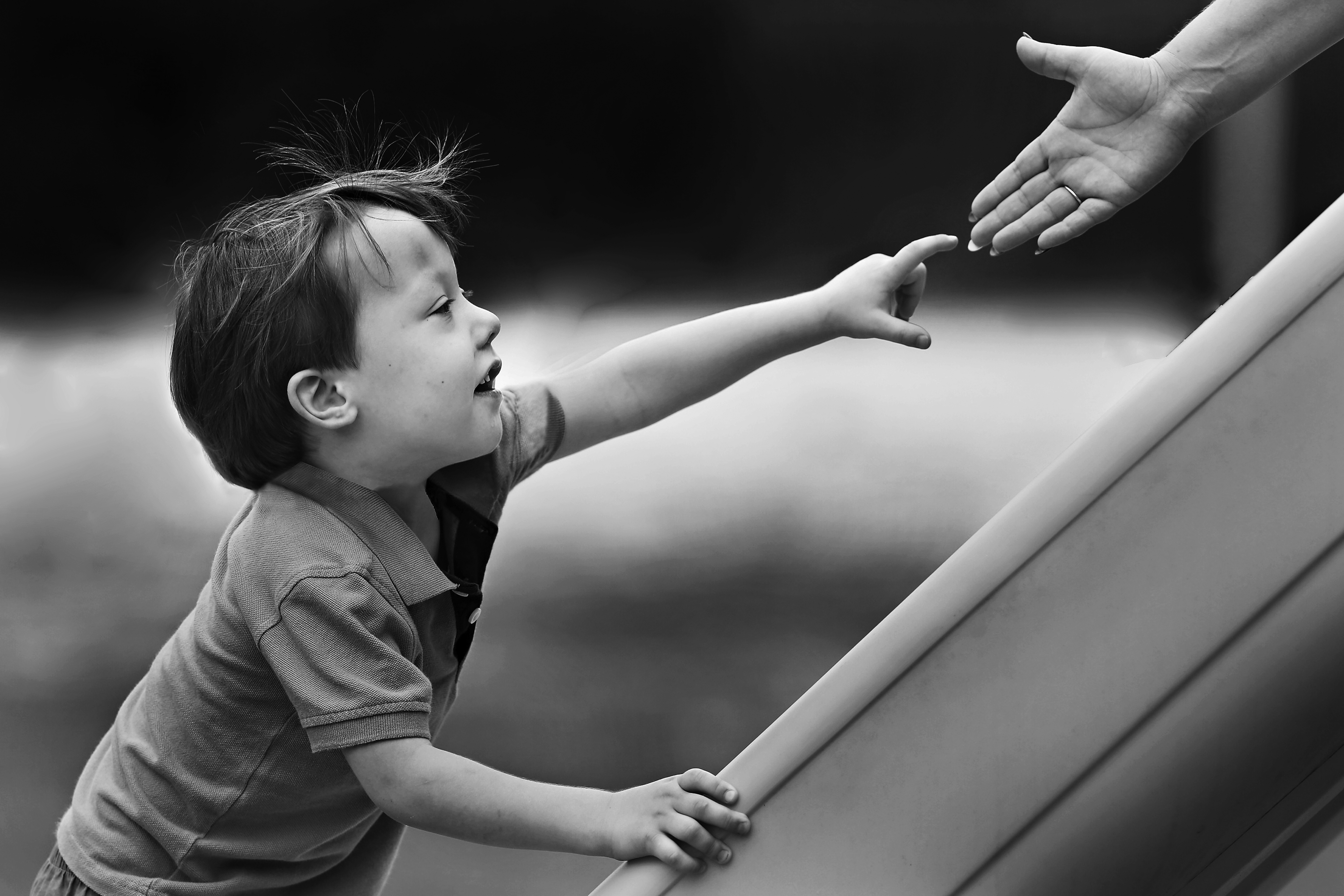 Child reaches for a hand