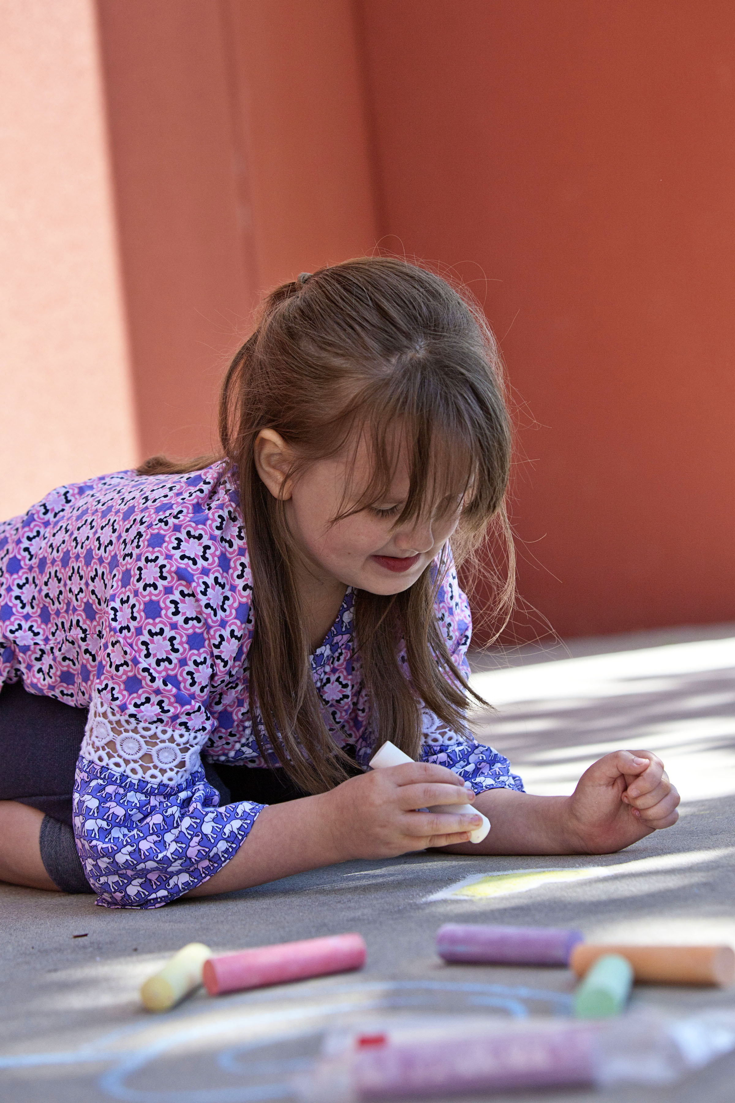 child plays with chalk