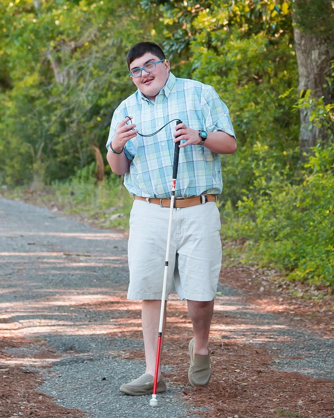 Andrew Delaney walks down a path in the park