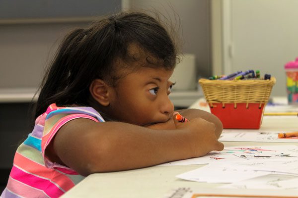 girl colors at an art table