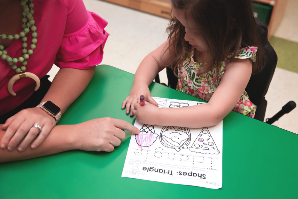 adult and child at table coloring