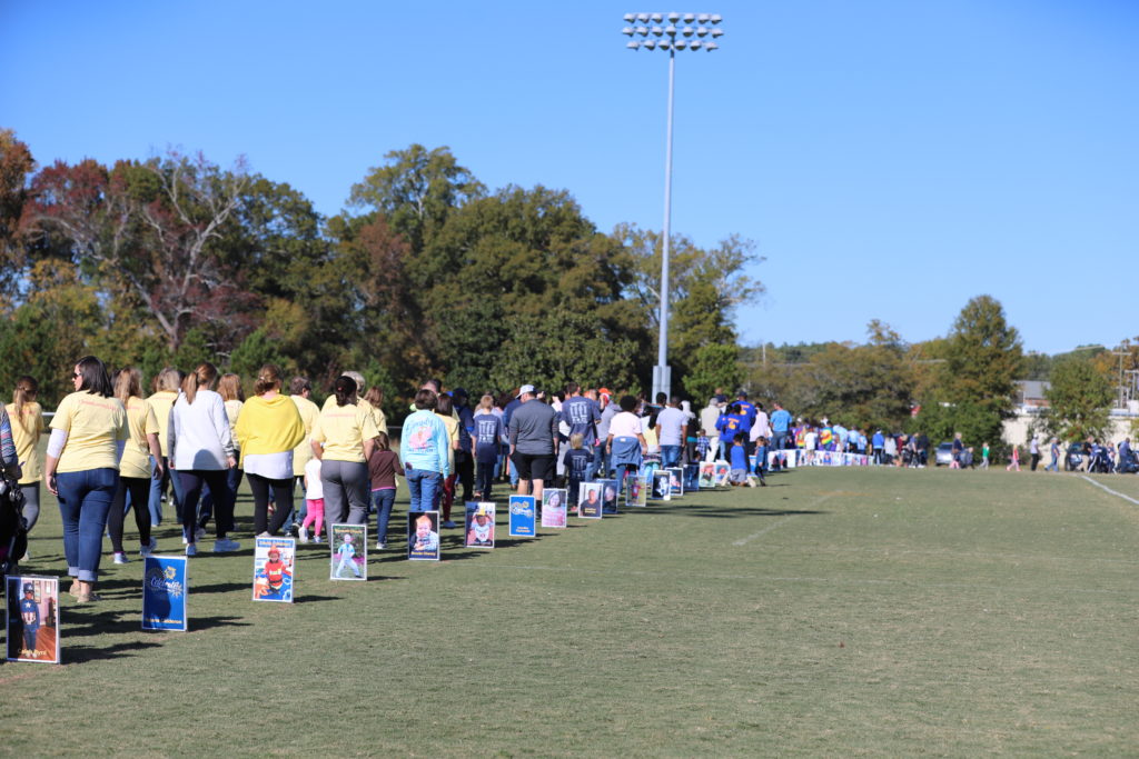 many people walking around a field