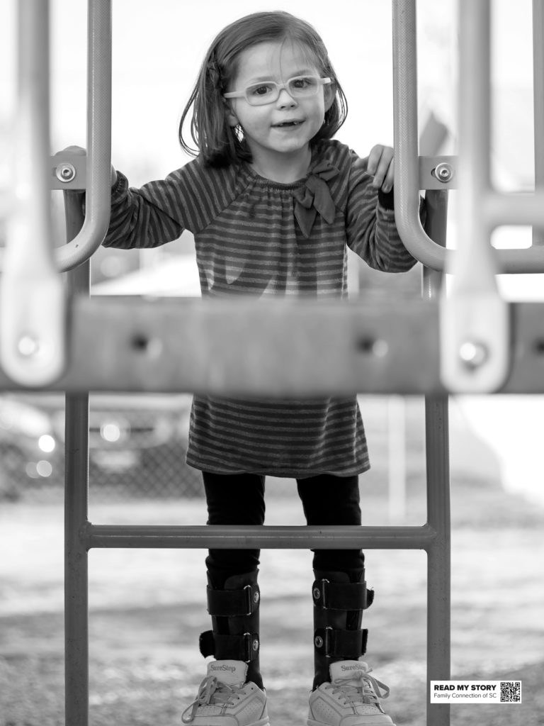 girl in glasses on jungle gym