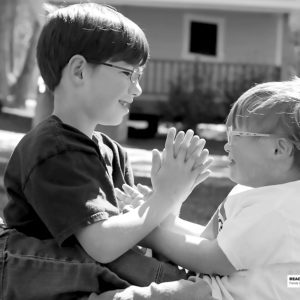 two boys playing patty cake