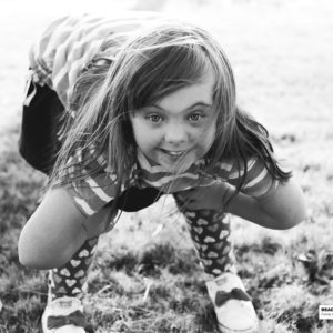 girl bent over smiling at camera