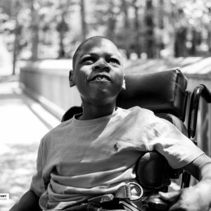 boy in wheelchair on bridge