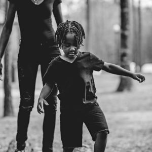 mom and son walking on a log