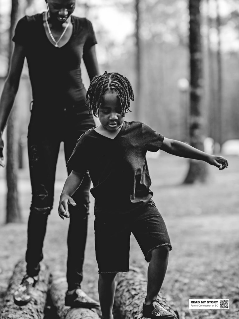 mom and son walking on a log