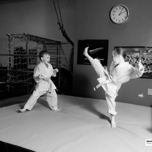boy and girl on karate mat