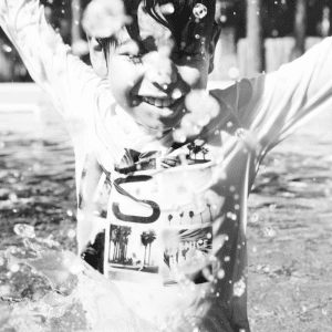 Boy splashes in a pool