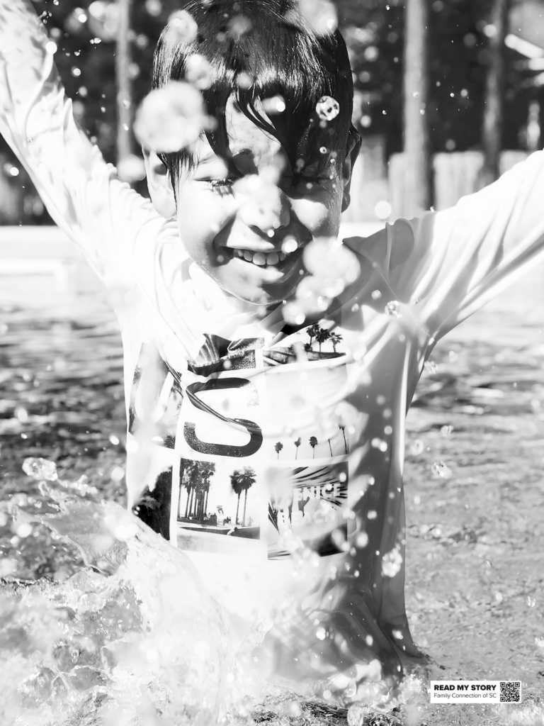 Boy splashes in a pool