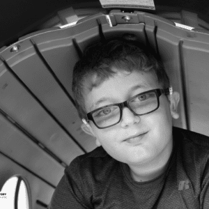 boy plays in a tunnel at a playground