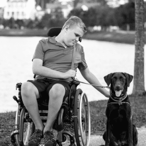 Young man sits with his dog