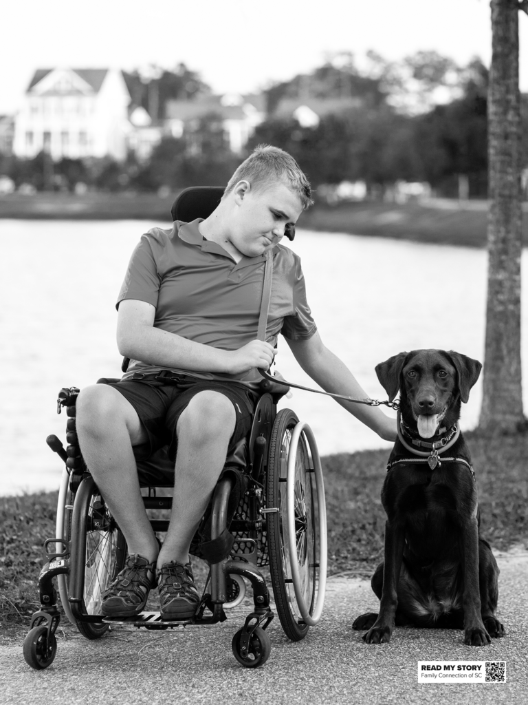 Young man sits with his dog