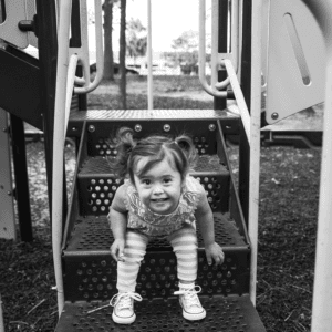 young girl plays on a playground