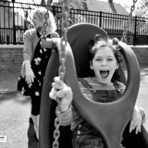 Girl laughs while swinging