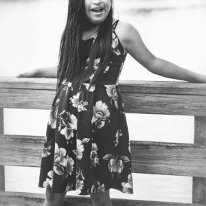 young woman stands on a dock