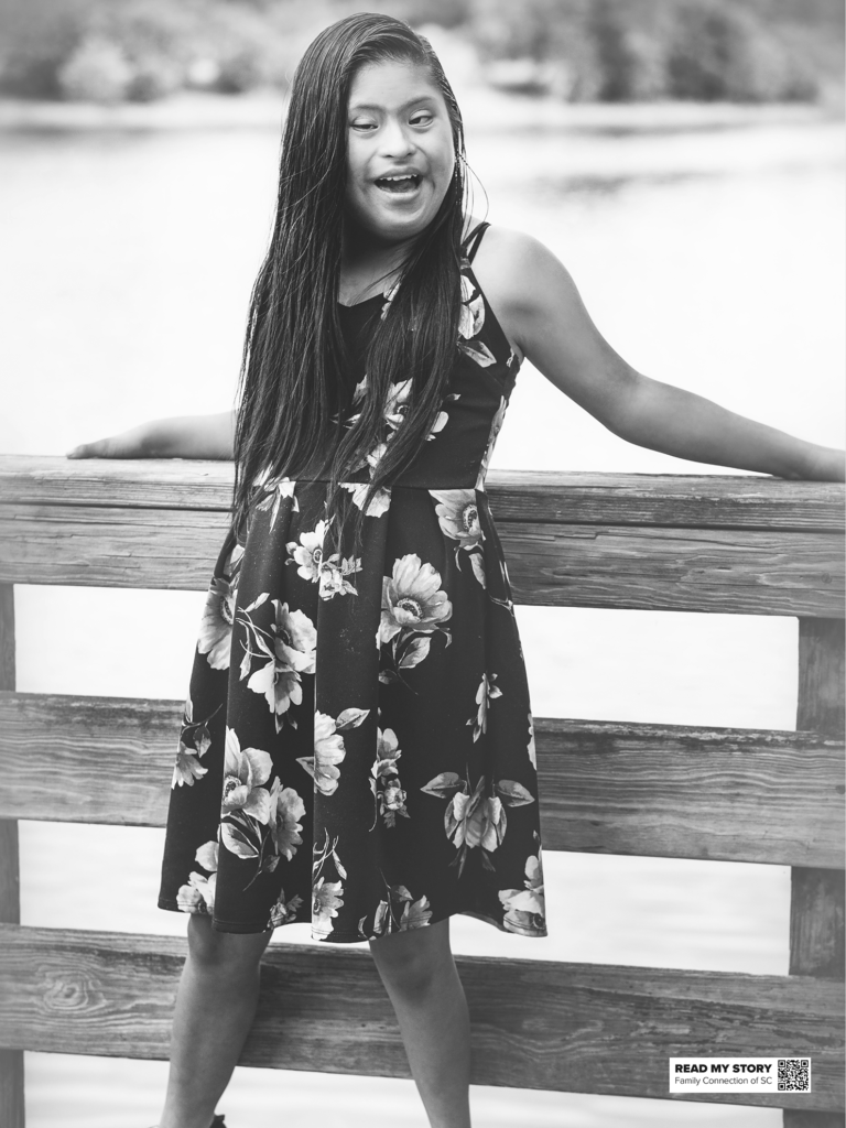 young woman stands on a dock