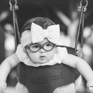 young girl sits in a swing