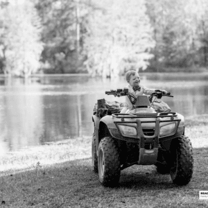 young boy sits on an ATV