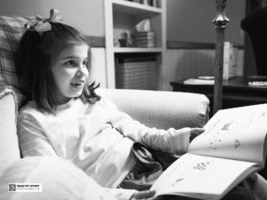 Girl reads a book in a chair