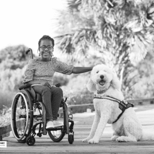 Girl sits on the boardwalk with her dog