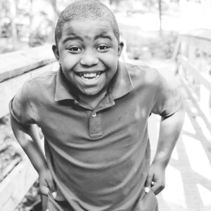 boy laughs on a bridge in the park