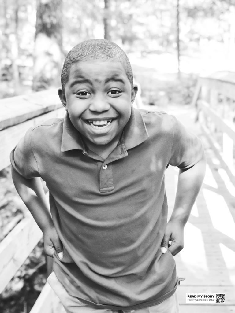 boy laughs on a bridge in the park