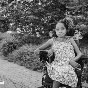 girl sits in her chair in the park