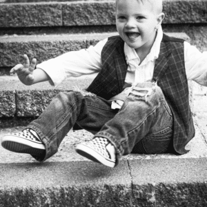 boy sits on some steps
