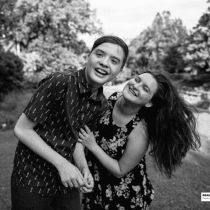 boy plays with his sister in a field