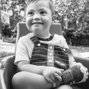 boy sits cross-legged in a wagon