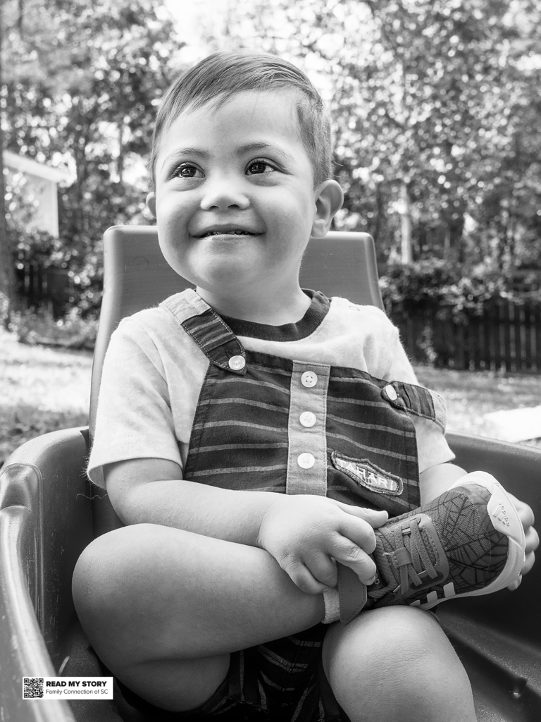 boy sits cross-legged in a wagon