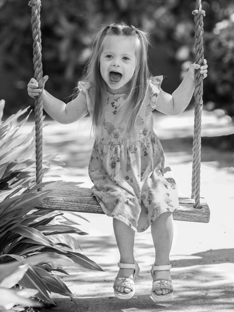 girl laughs on swing