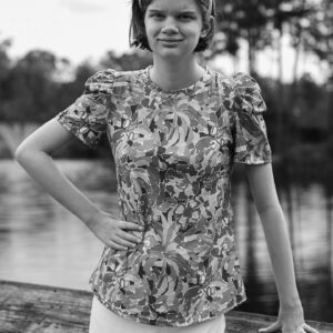 young woman smiles by the water