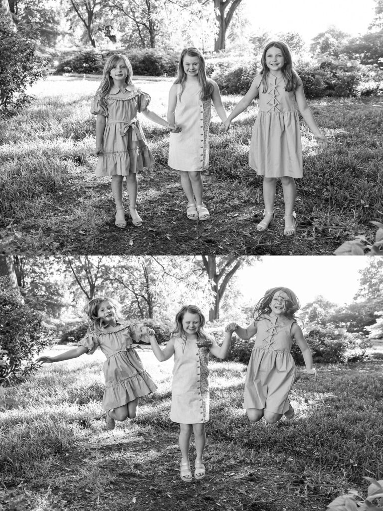 three girls laugh and jump together holding hands