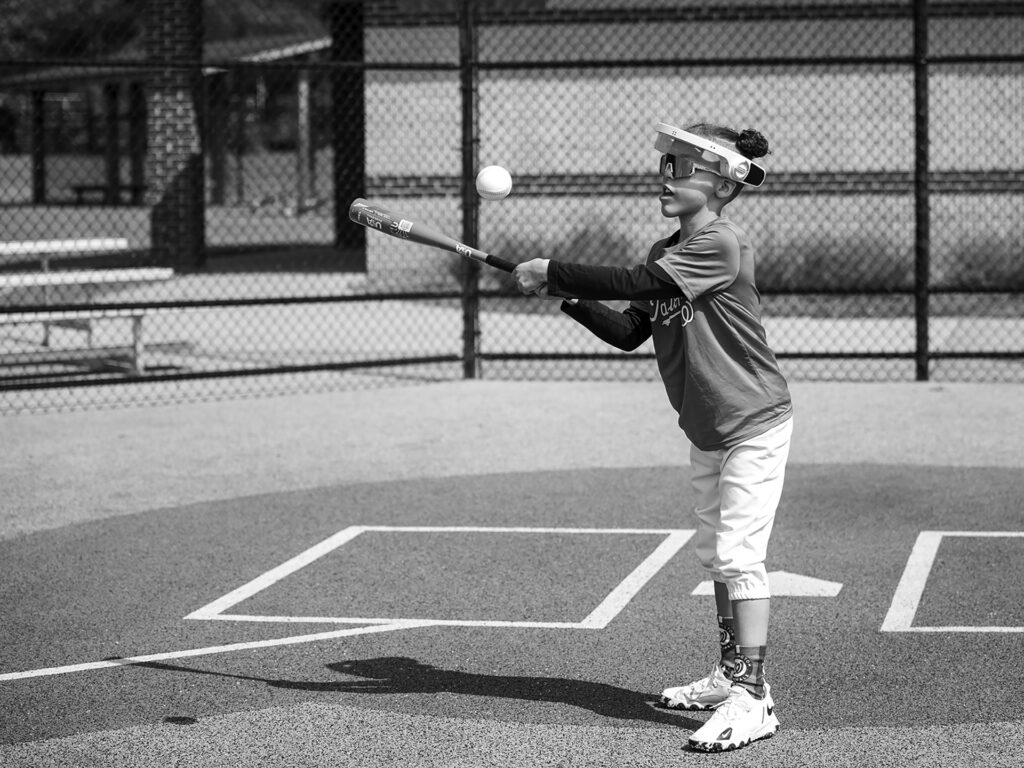 boy plays baseball