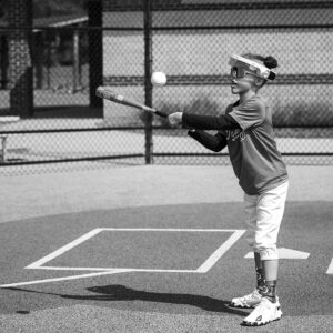 boy plays baseball