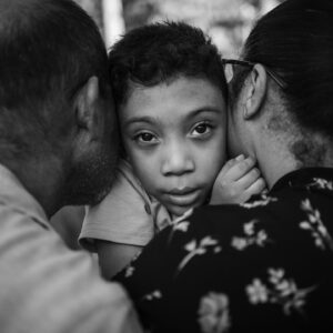 boy hugs his parents