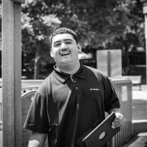 young man smiles with is ipad