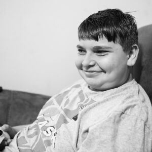 young man smiles playing video games