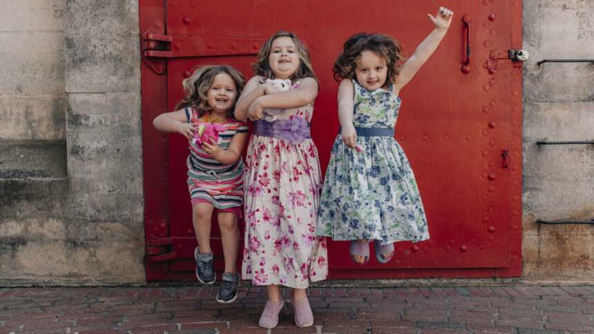 three girls jump and play
