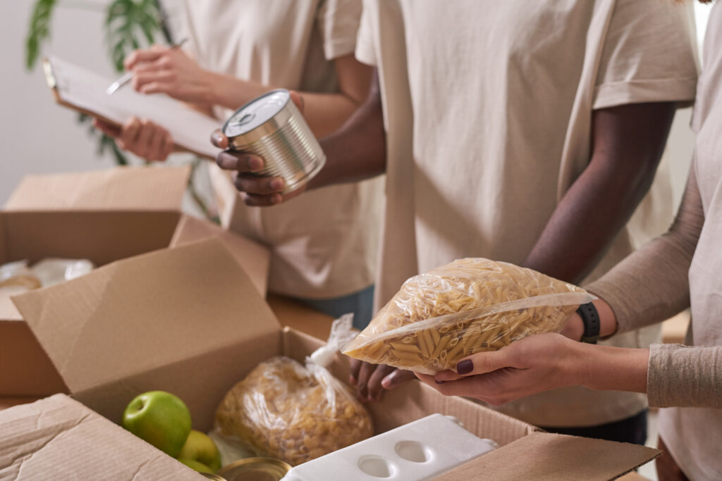 Volunteers Packing Food For Donation