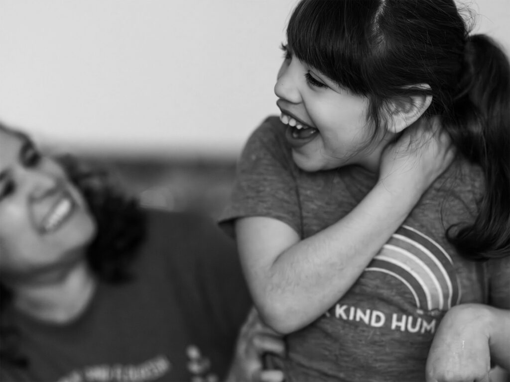 girl laughs with her mom