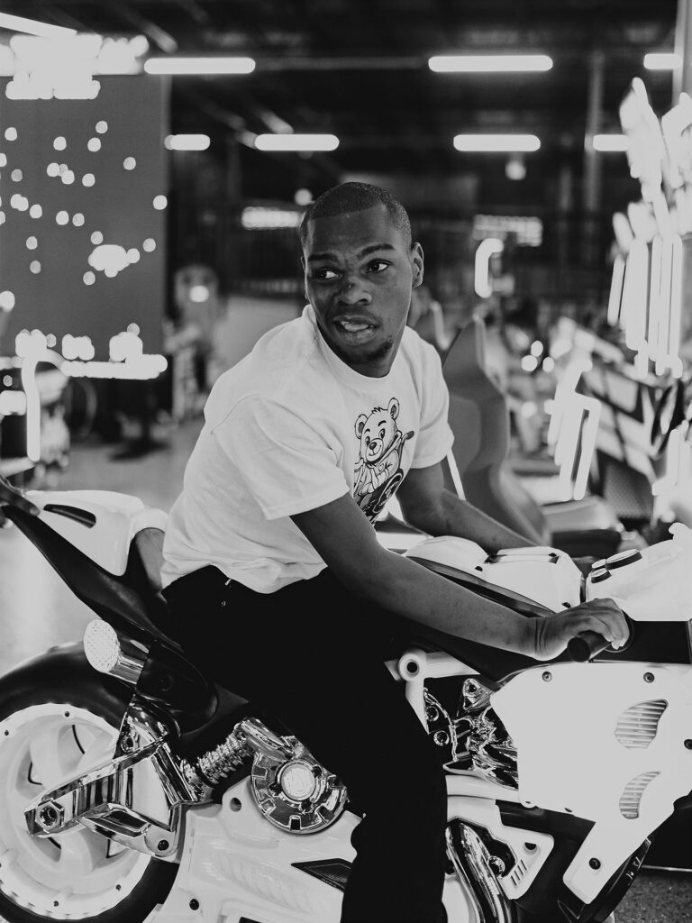 young man on a motorcycle game at an arcade