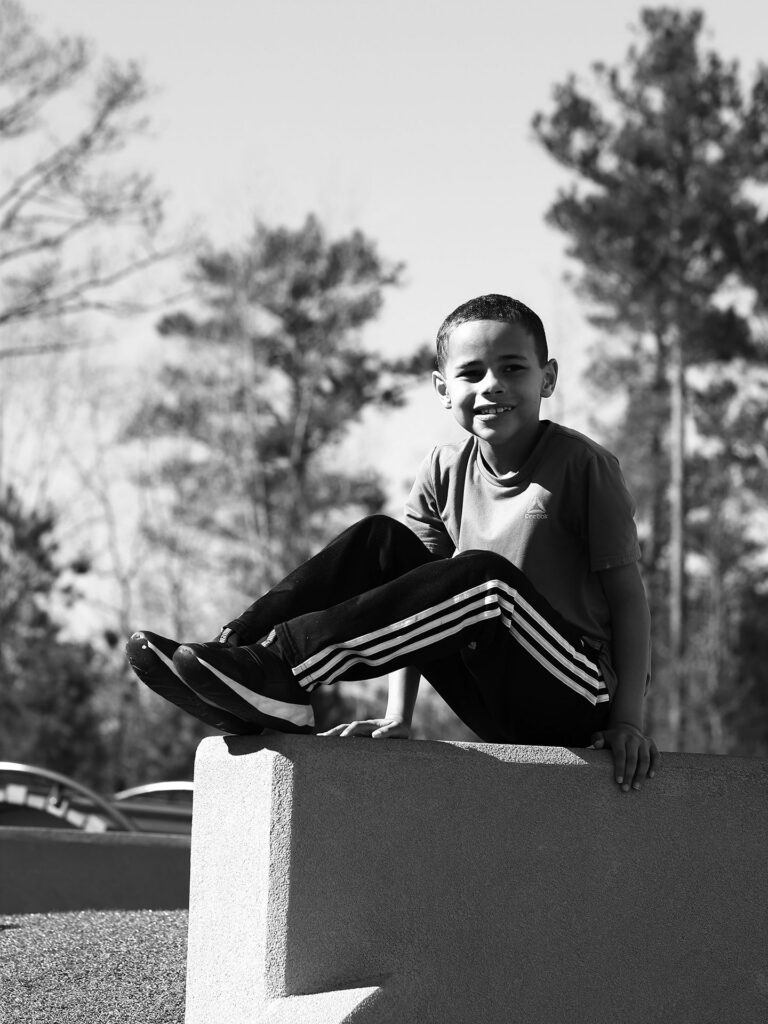 boy sits on a wall